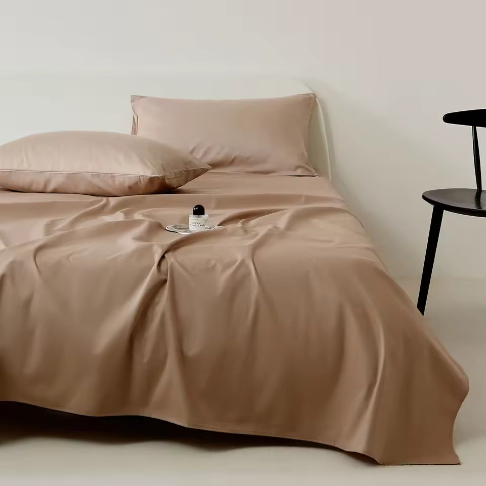Beige bedding set on a bed with a minimal background