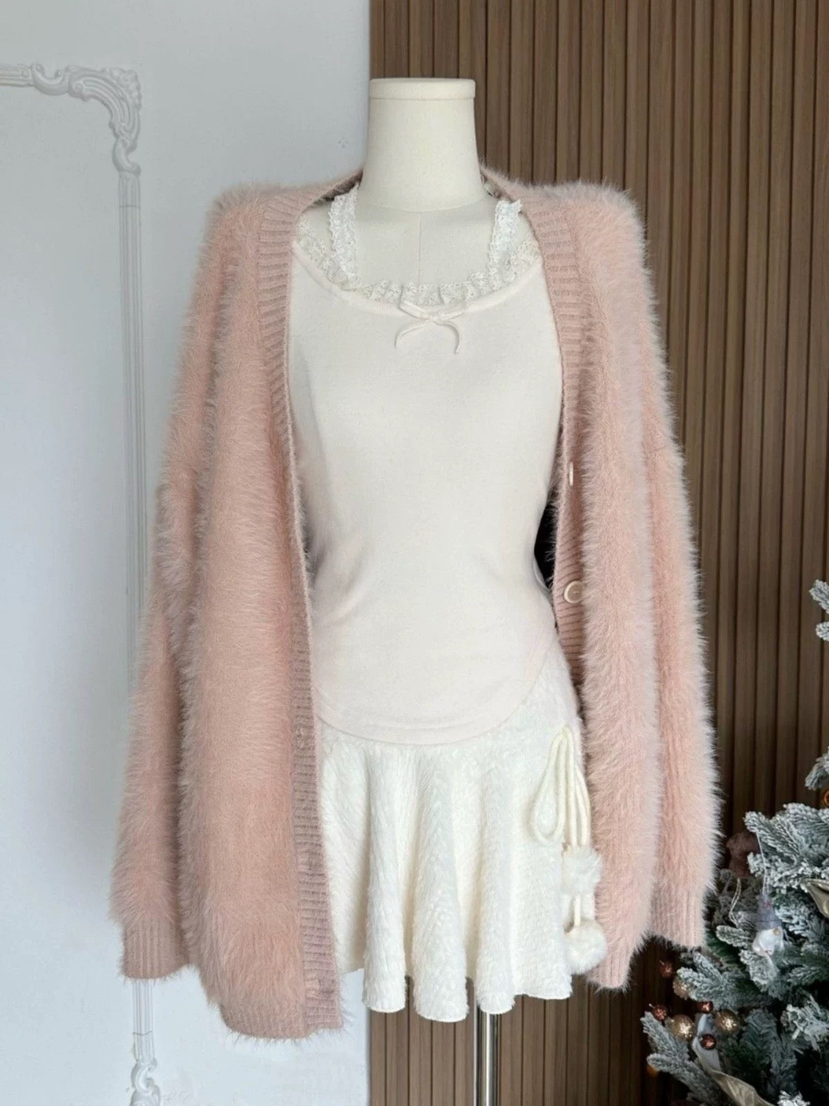 Model styling white mini skirt with ballet flats