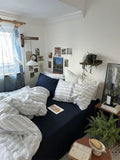 Cozy bedroom with a bed, pillows, and decor elements.