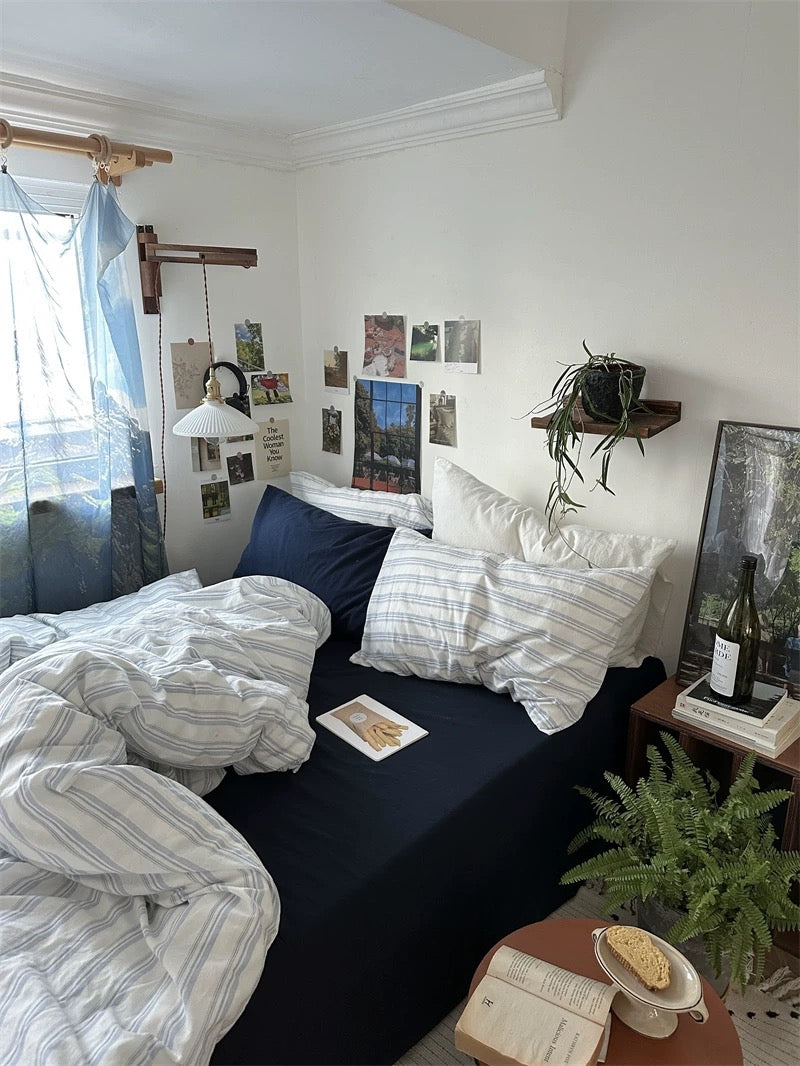 Cozy bedroom with a bed, pillows, and decor elements.
