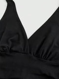 Black swimsuit top on a white background