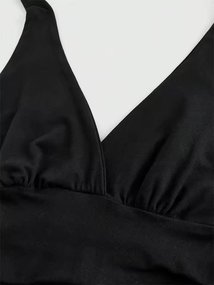 Black swimsuit top on a white background