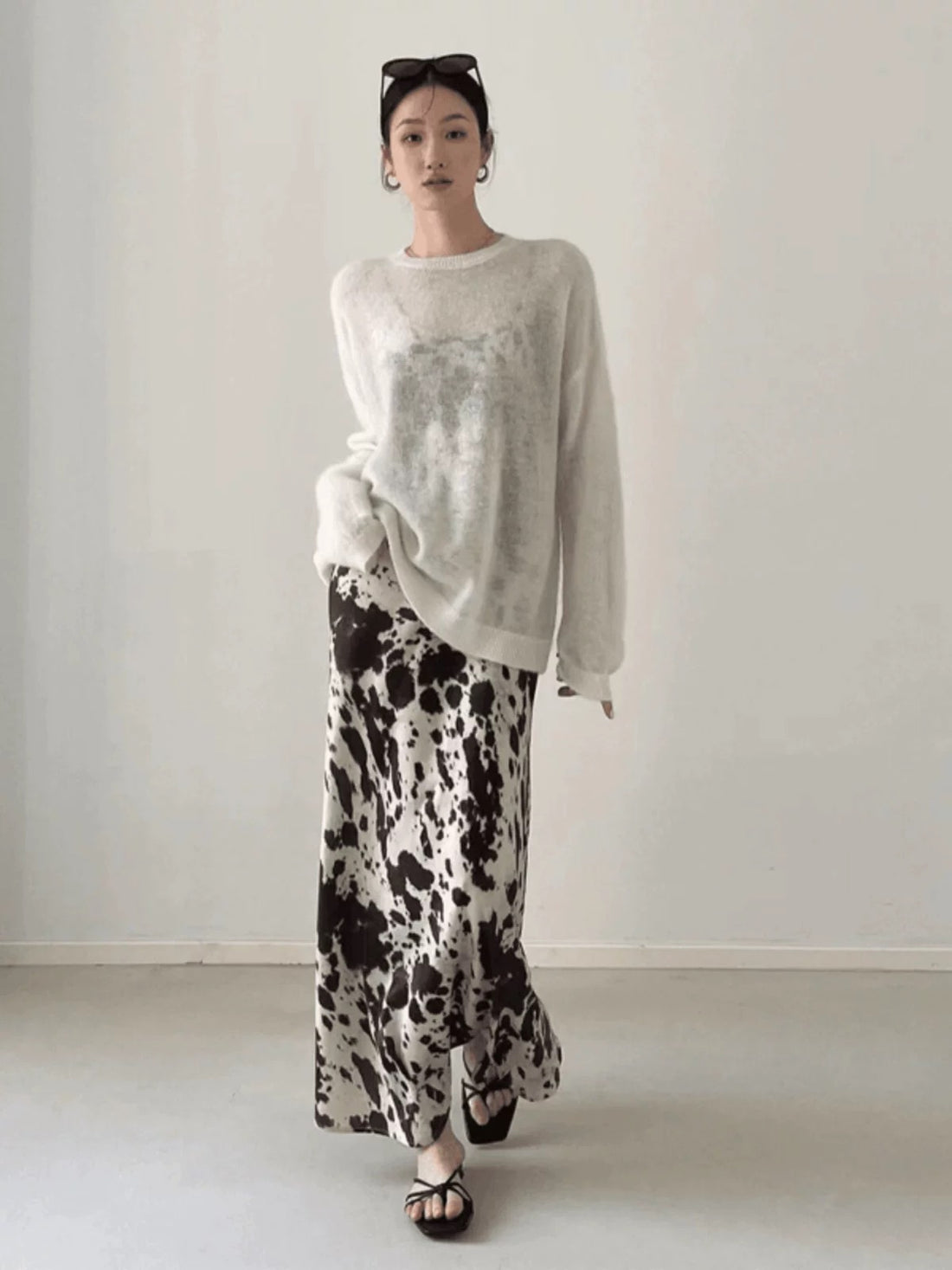 Front view of the leopard print satin midi skirt showcasing its high-waist design and flowing silhouette.
