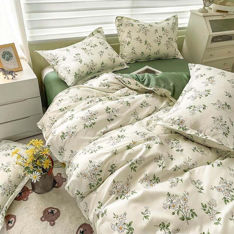 Floral bedding set on a bed with matching pillows in a bedroom setting.