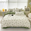Floral bedding set on a bed in a bedroom with white walls and furniture.