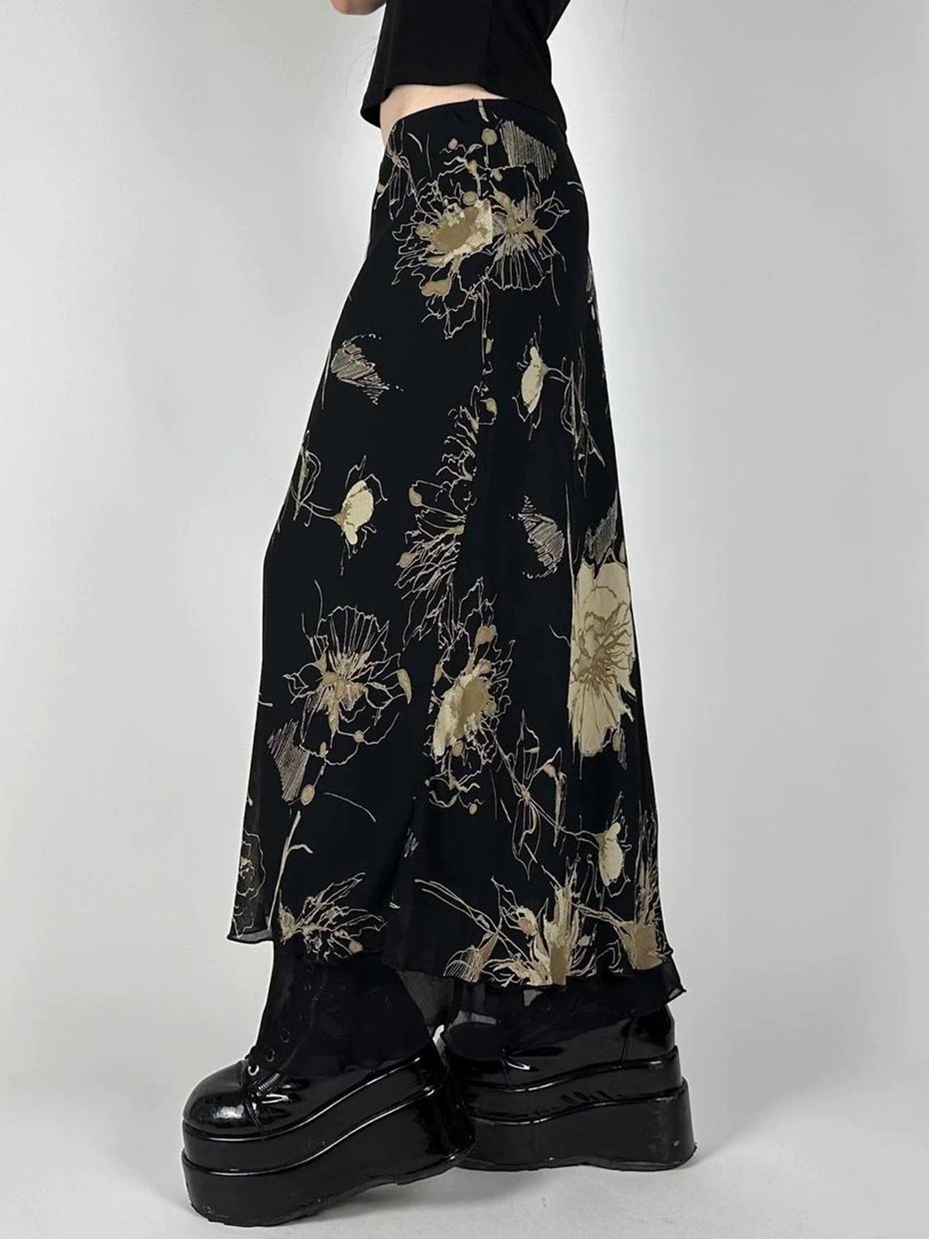 Model pairing the skirt with a black crop top and combat boots, illustrating a grunge aesthetic.