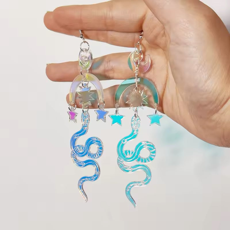 Fairycore moon and serpent earrings made from laser cut acrylic, ideal for witchy, coquette, or celestial styles