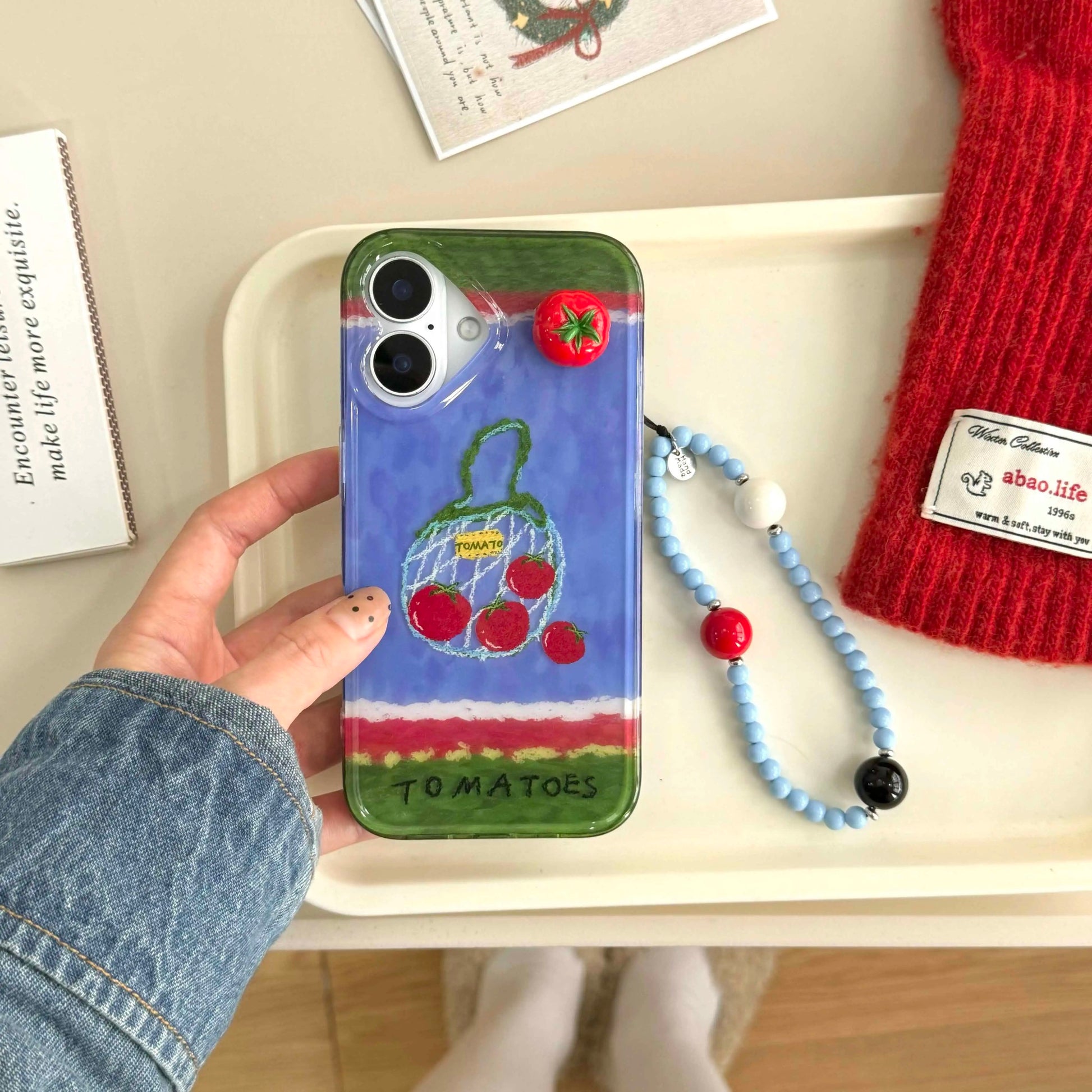 Back view displaying the detailed tomato artwork and secure fit on iPhone