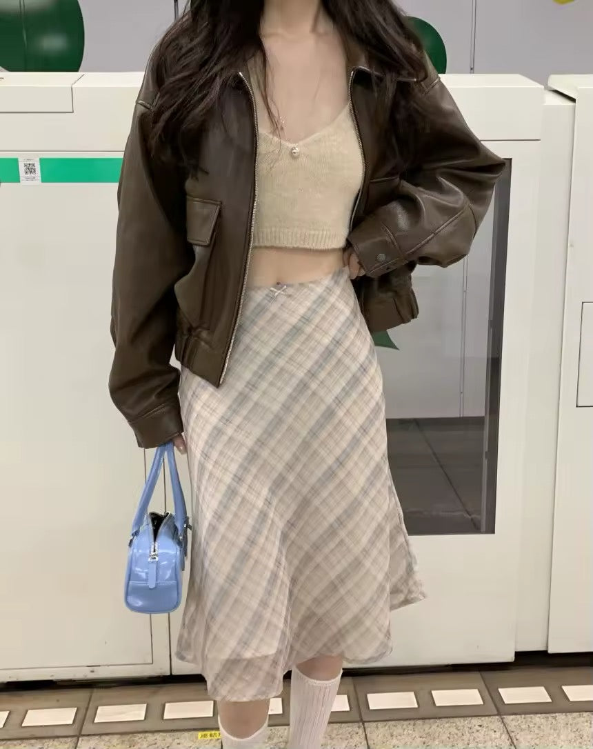 Vintage plaid midi skirt styled with brown jacket in subway