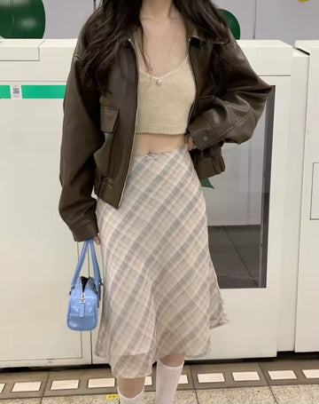 Vintage plaid midi skirt styled with brown jacket in subway