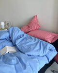 Washed cotton blue duvet cover with plaid accents in simple dorm room