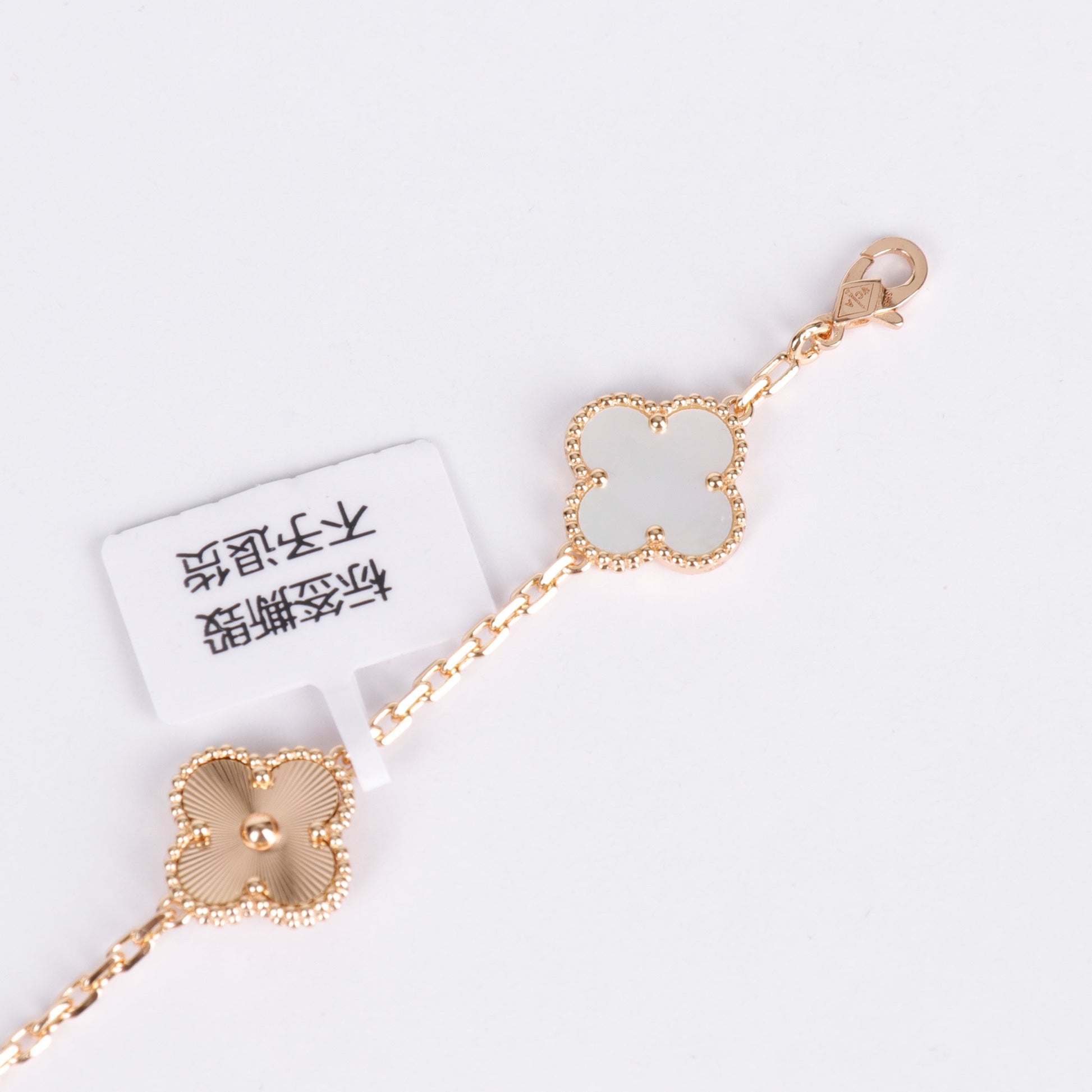 V-Gold bracelet with white clover enamel and designer charm