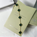 Designer gold bracelet with green lucky clover charm