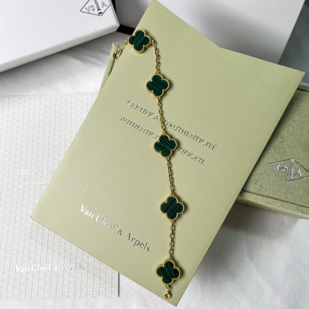 Designer gold bracelet with green lucky clover charm