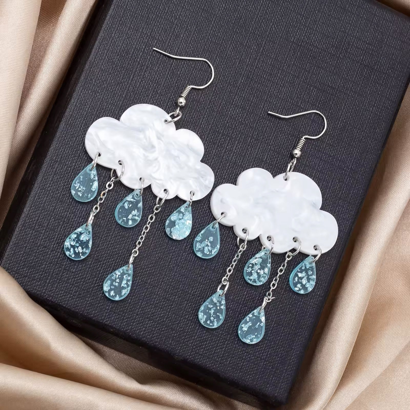 Pastel-colored rain cloud earrings with acrylic shapes and resin teardrop charms, perfect for fairycore, kidcore, or dreamy outfits