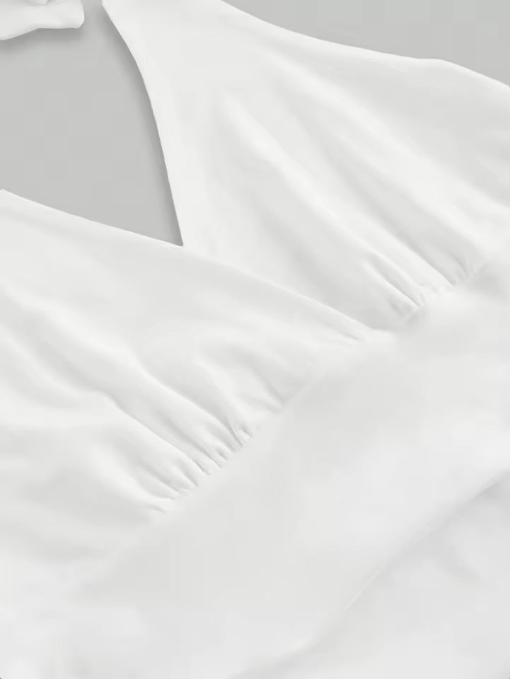 Close-up of white satin fabric with a soft texture on a light gray background