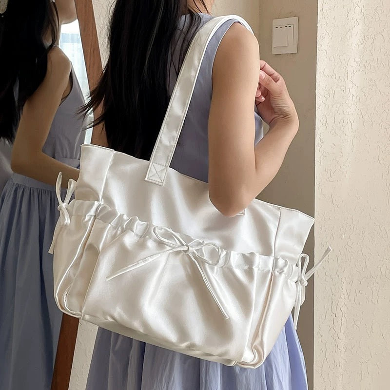 Close-up of satin texture and bow detail on bag