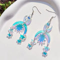 Laser-cut acrylic earrings featuring snake coiled around moon, witchy statement earrings with iridescent finish