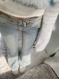 Closeup of women’s aesthetic Y2K jeans in vintage gray denim