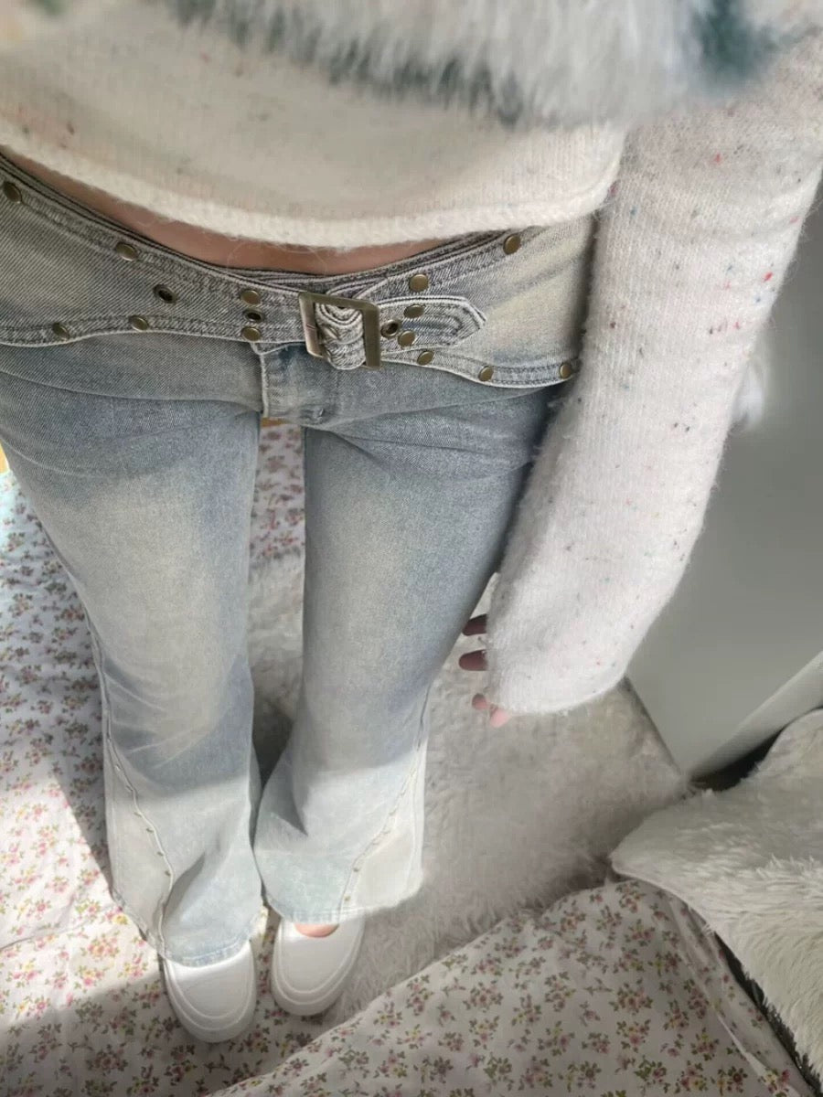 Closeup of women’s aesthetic Y2K jeans in vintage gray denim