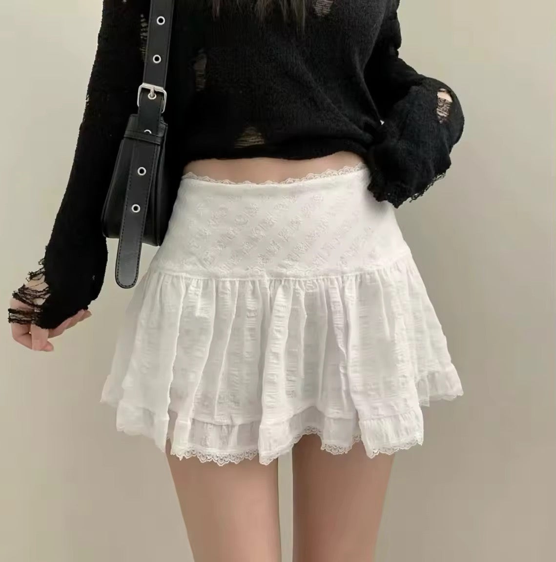 White tiered mini skirt styled for summer
