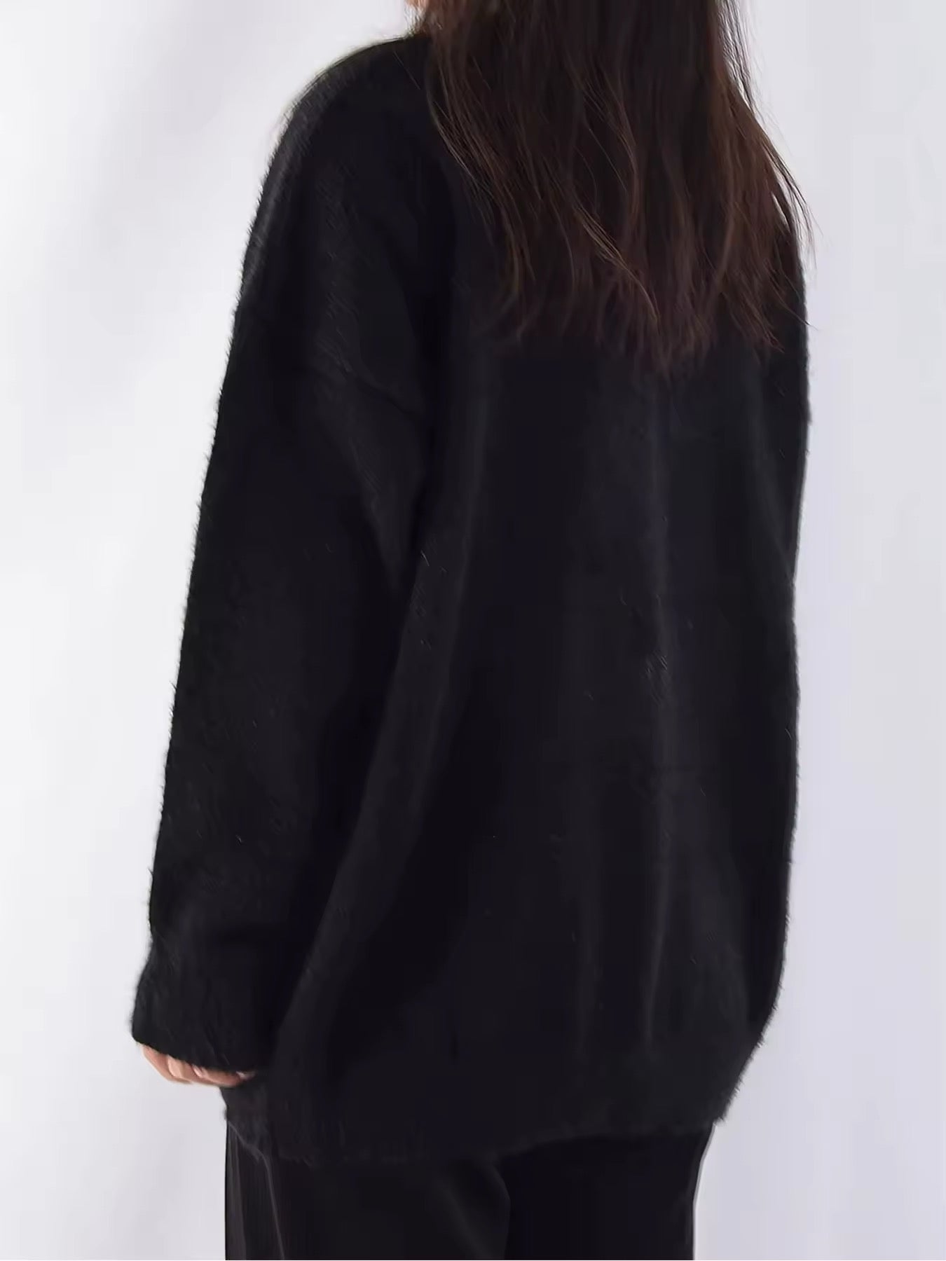 Close-up of the sweater's white graphic design featuring a creepy cute devil cat for Harajuku vibes.