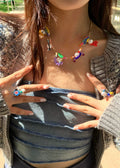 Cute Y2K colorful beaded necklace featuring cartoon character charms, a trendy collar bone chain, and vintage aesthetic jewelry for stylish girls