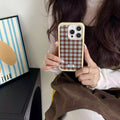 The iPhone case held in hand, demonstrating its ergonomic design and style