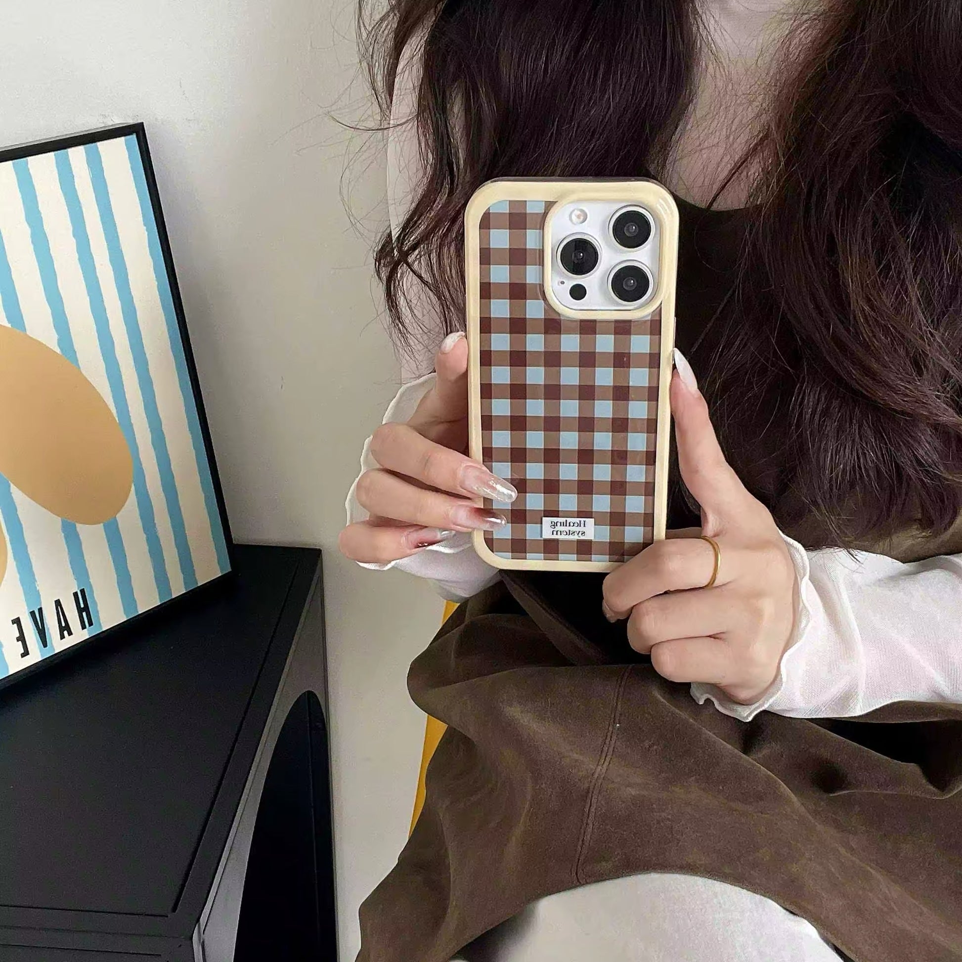 The iPhone case held in hand, demonstrating its ergonomic design and style