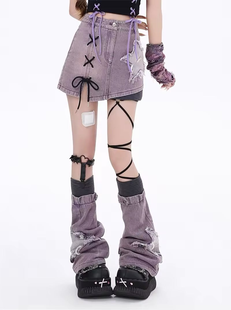 Model wearing purple mini skirt with crossover ribbon detail and cutout threads