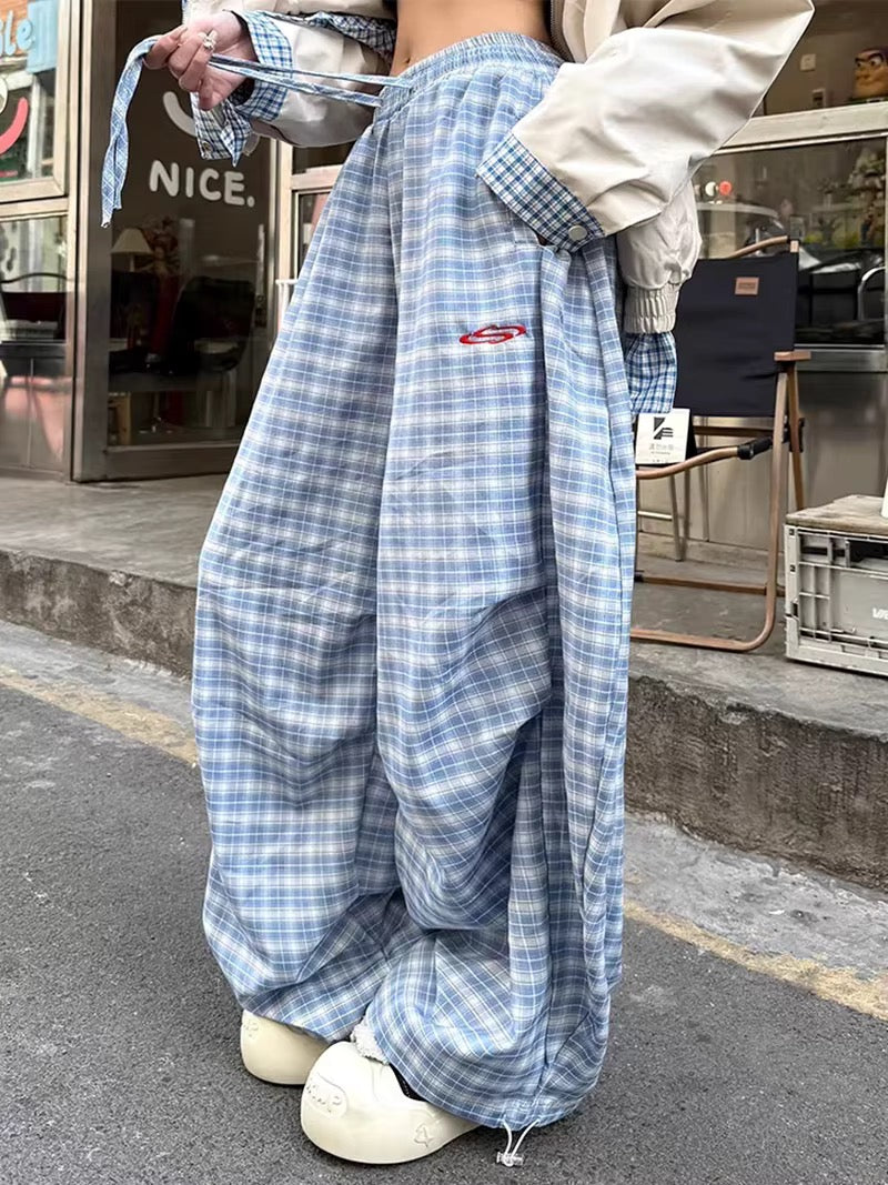 Light blue plaid wide leg pants with elastic waistband and drawstring, styled for Y2K streetwear