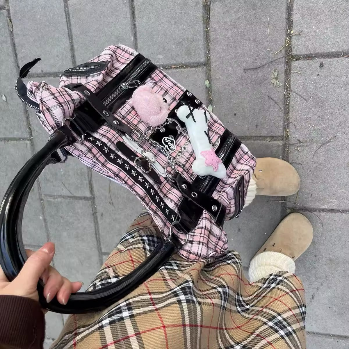 The bag placed on a grunge-themed backdrop, highlighting its alt fashion appeal.