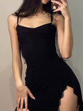 Chic black dress featuring ruffled hem and sultry details