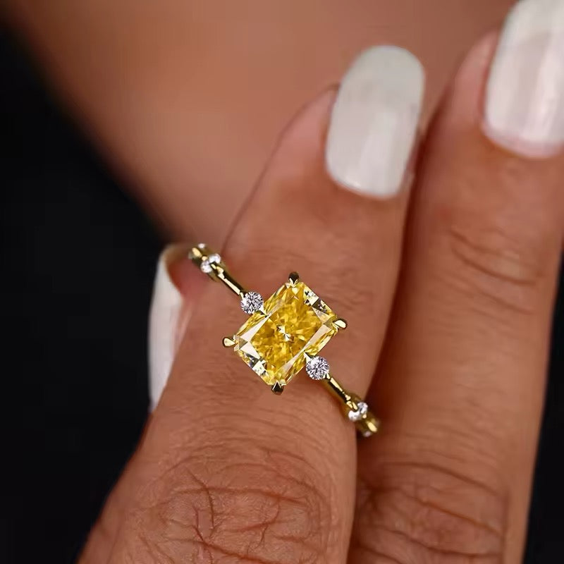 Elegant yellow crystal ring on white background
